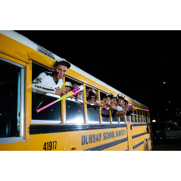 Player holding 2026 Easton The Dub USSSA Bat in bus.